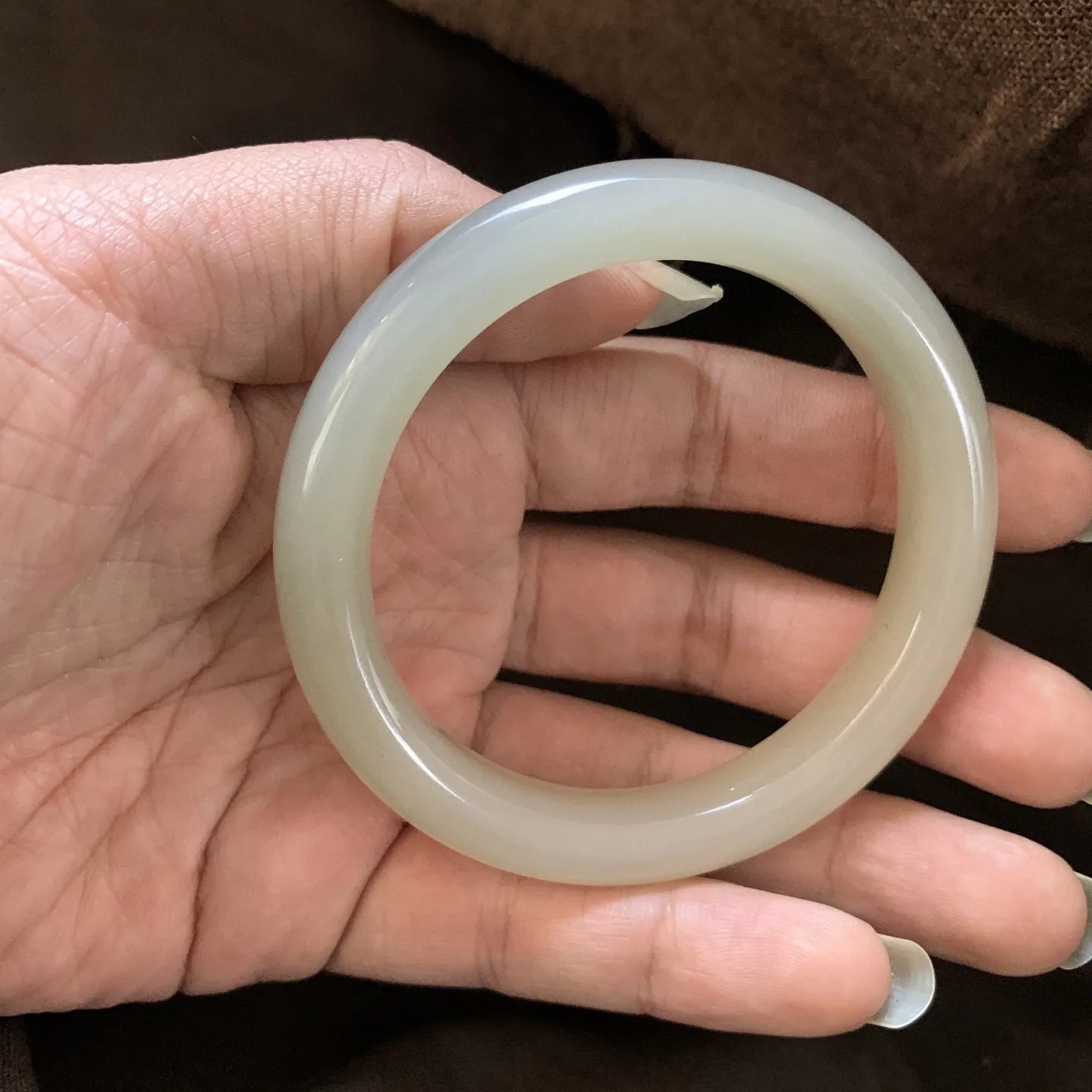 和田玉58圈口藕粉色手镯，两色藕粉，镯型古朴典雅。在诗情画意的雨巷相遇，你是我腕间的一抹风情，有你眸有深情.清风荡漾湖间静水，我愿俯身低眉，在烟波涟漪处寻