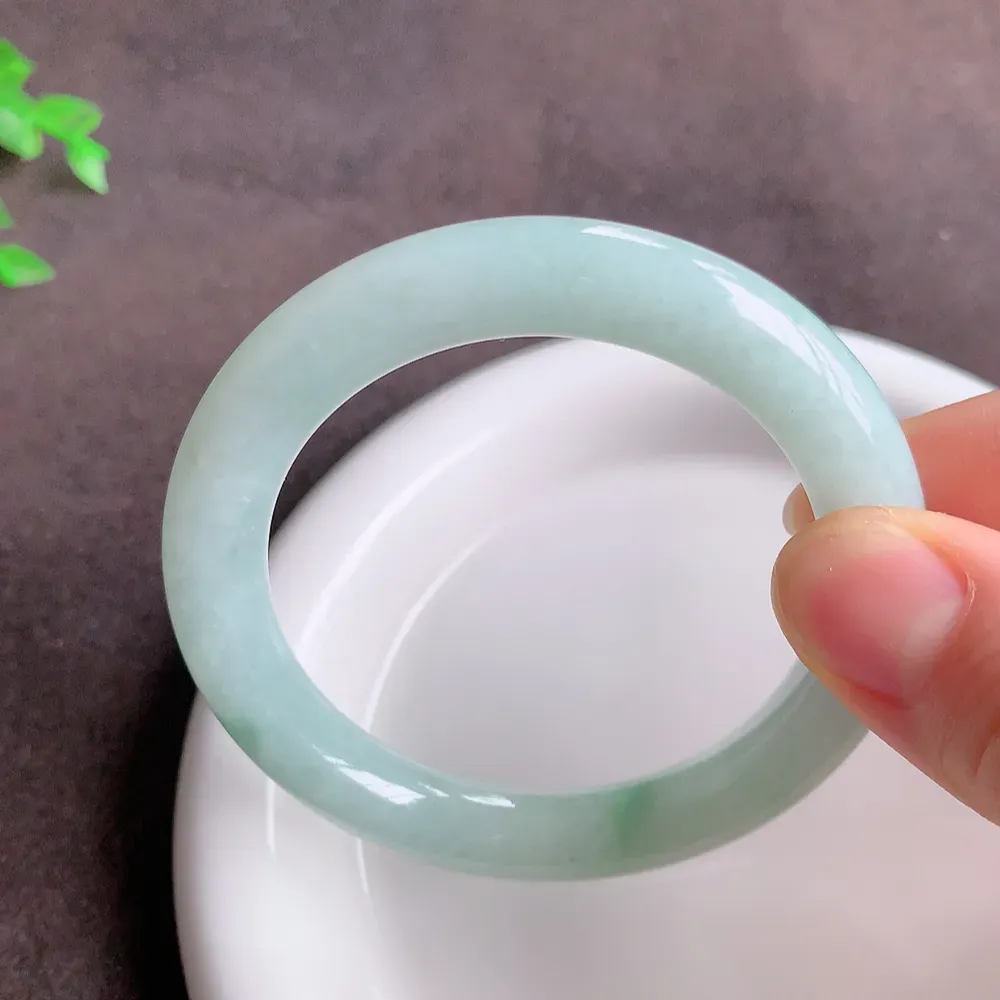 缅甸飘花翡翠圆条手镯55mm  冰润飘花圆条翡翠手镯，玉质细腻水润，色泽清秀亮丽，飘花灵动  上手高贵典雅，W922.27  尺寸：55-10mm