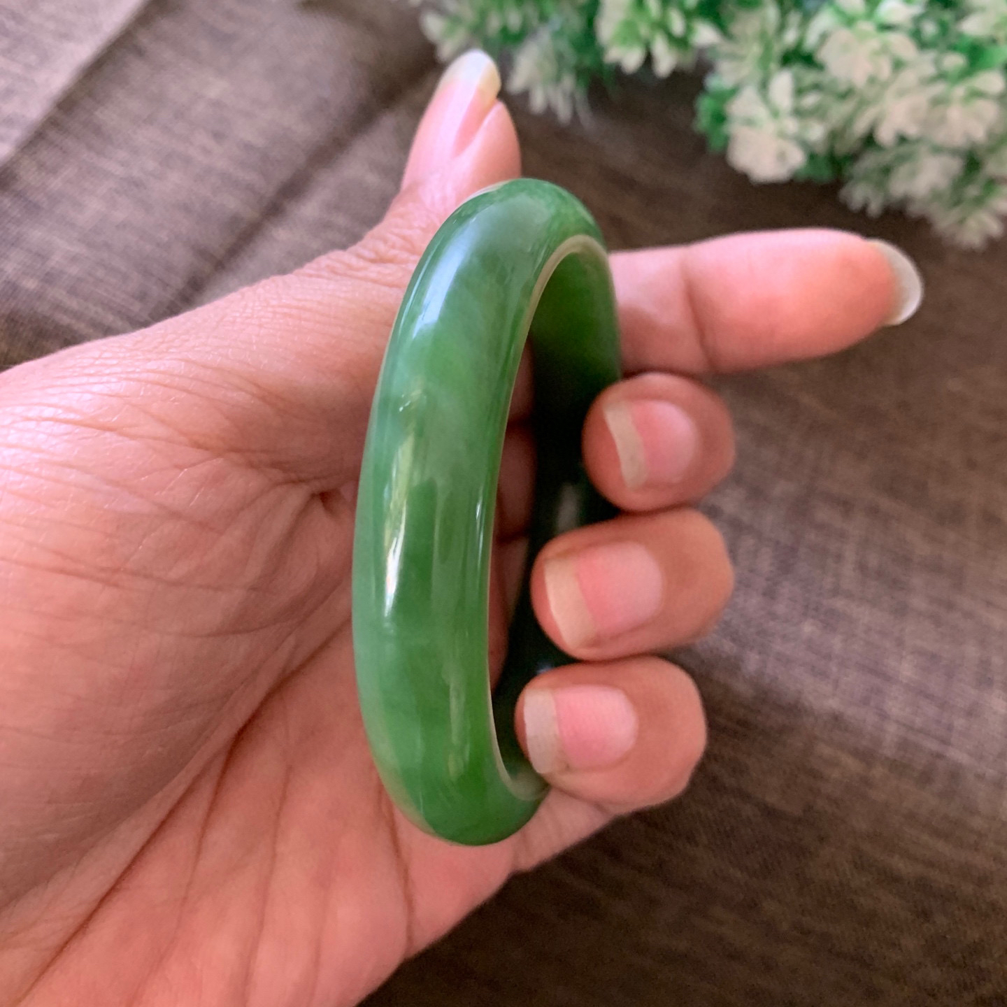 和田玉55圈口阳绿色猫眼手镯，镯型古朴典雅。在诗情画意的雨巷相遇，你是我腕间的一抹风情，有你眸有深情.清风荡漾湖间静水，我愿俯身低眉，在烟波涟漪处寻