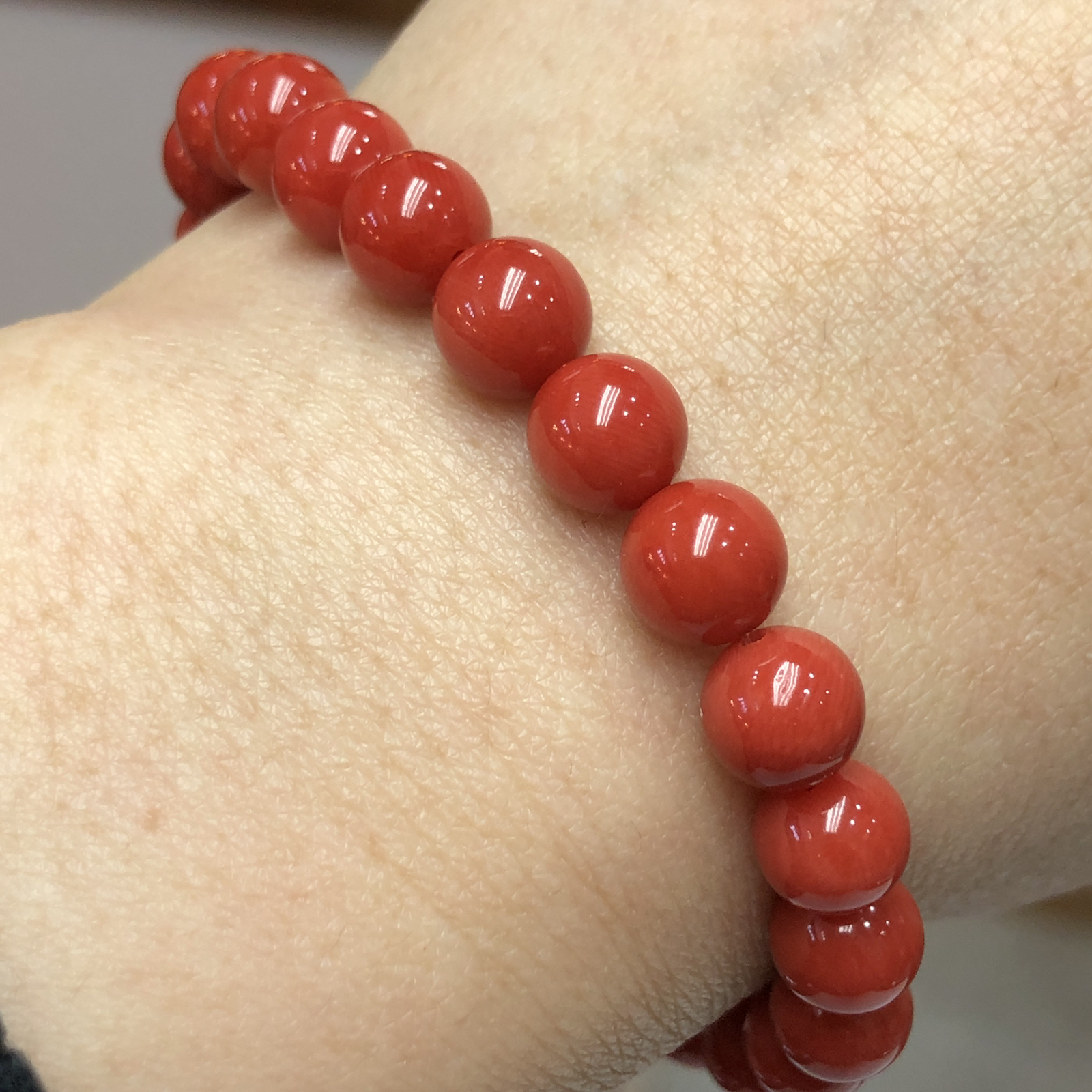 【天然深橘红珊瑚7.6mm圆珠弹力单手串】深橘红颜色，光泽柔润透亮，直径约7.6-7.2mm，重量14.22克。珊瑚本为佛教珍宝，来自深海千年生长，属于有机宝石，气场强大，材料意大利沙丁材料，稀少珍贵！每粒均为天然无添加无修补！收藏精品！传承宝贝！