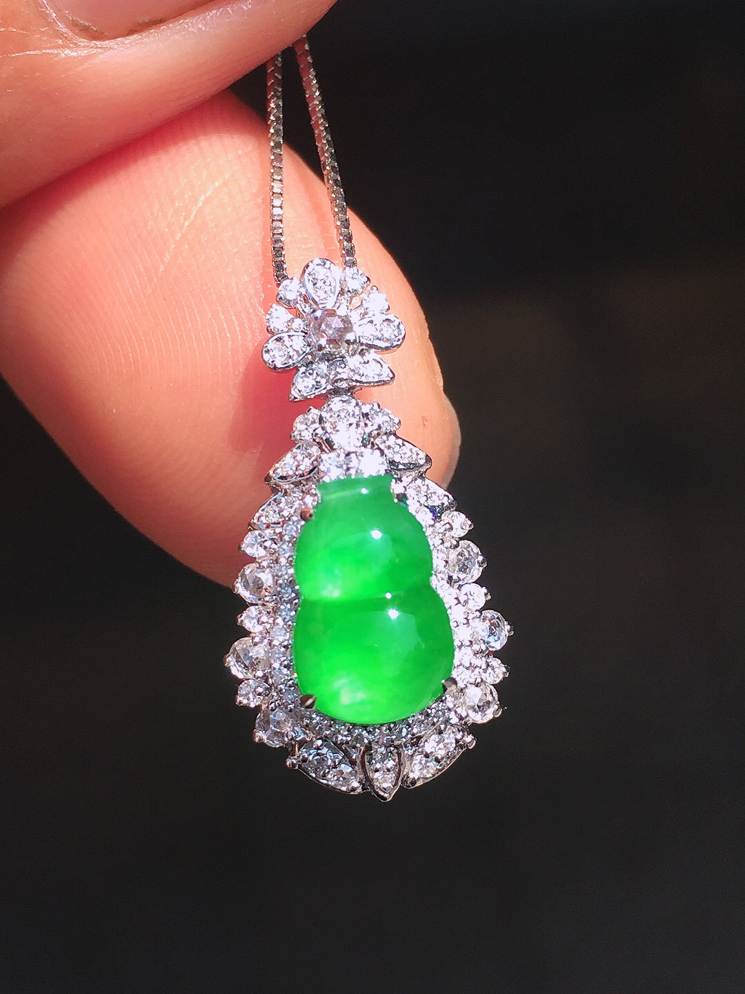 阳绿葫芦吊坠，色泽均匀艳丽，玉质细腻，荧光感超
强，饱满圆润，尽显优雅气质，18k
金豪华镶嵌