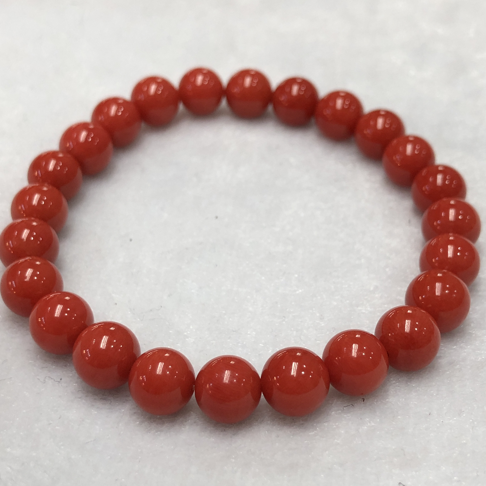 【天然深橘红珊瑚7.6mm圆珠弹力单手串】深橘红颜色，光泽柔润透亮，直径约7.6-7.2mm，重量1