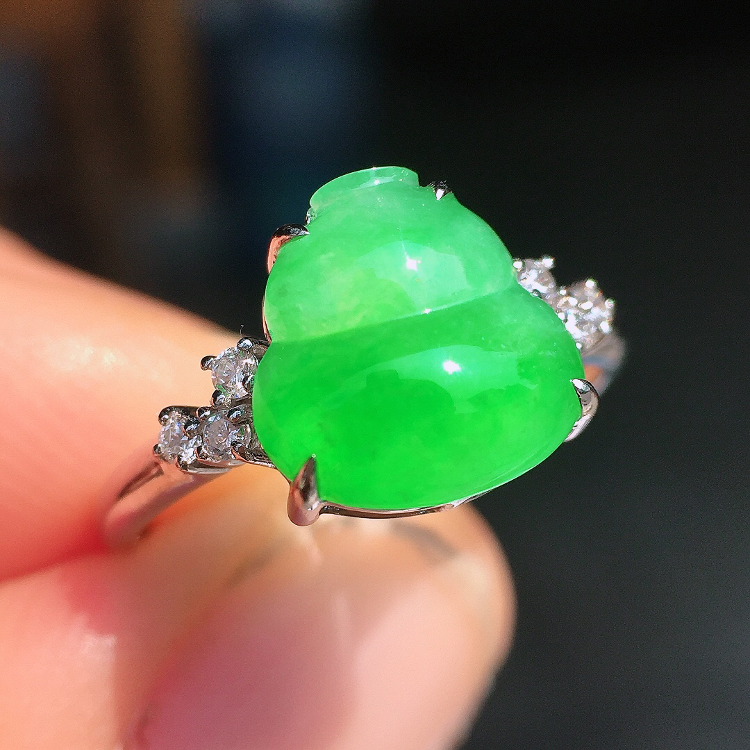 阳绿葫芦戒指，色泽均匀艳丽，玉质细腻，荧光感超
强，饱满圆润，尽显优雅气质，18k
金豪华镶嵌