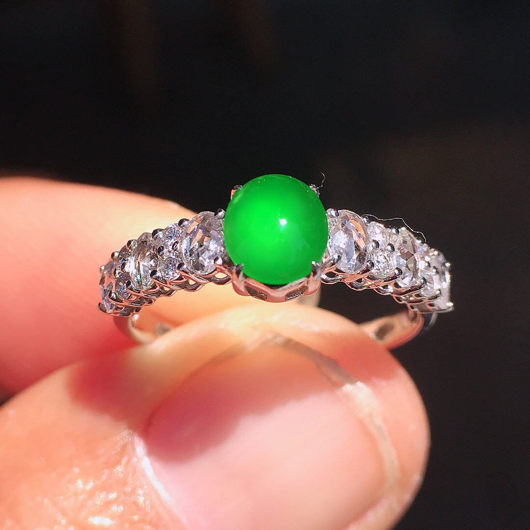 阳绿蛋面戒指，色泽均匀艳丽，玉质细腻，荧光感超
强，饱满圆润，尽显优雅气质，18k
金豪华镶嵌