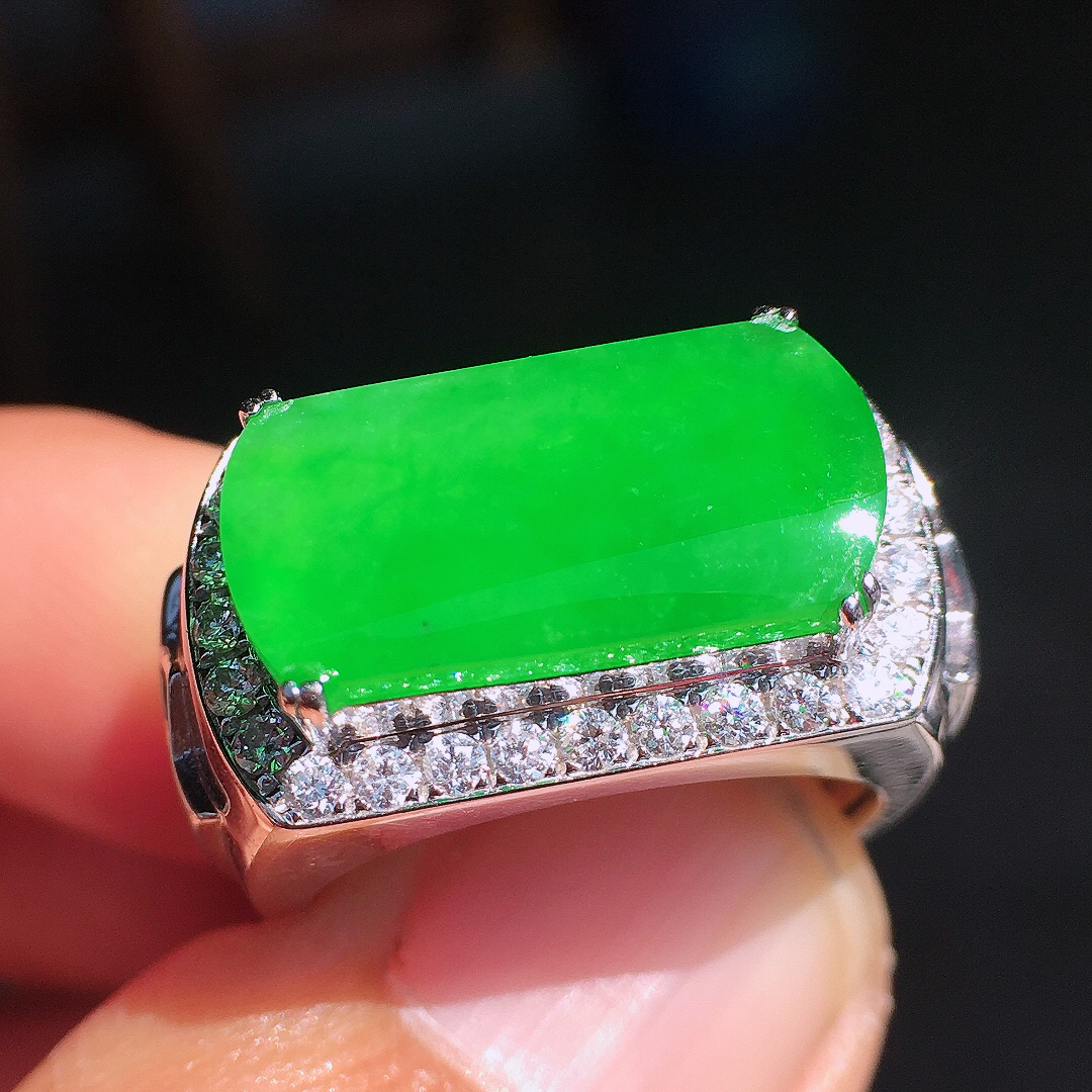 阳绿马鞍戒指，色泽均匀艳丽，玉质细腻，荧光感超
强，饱满圆润，尽显优雅气质，18k
金豪华镶嵌