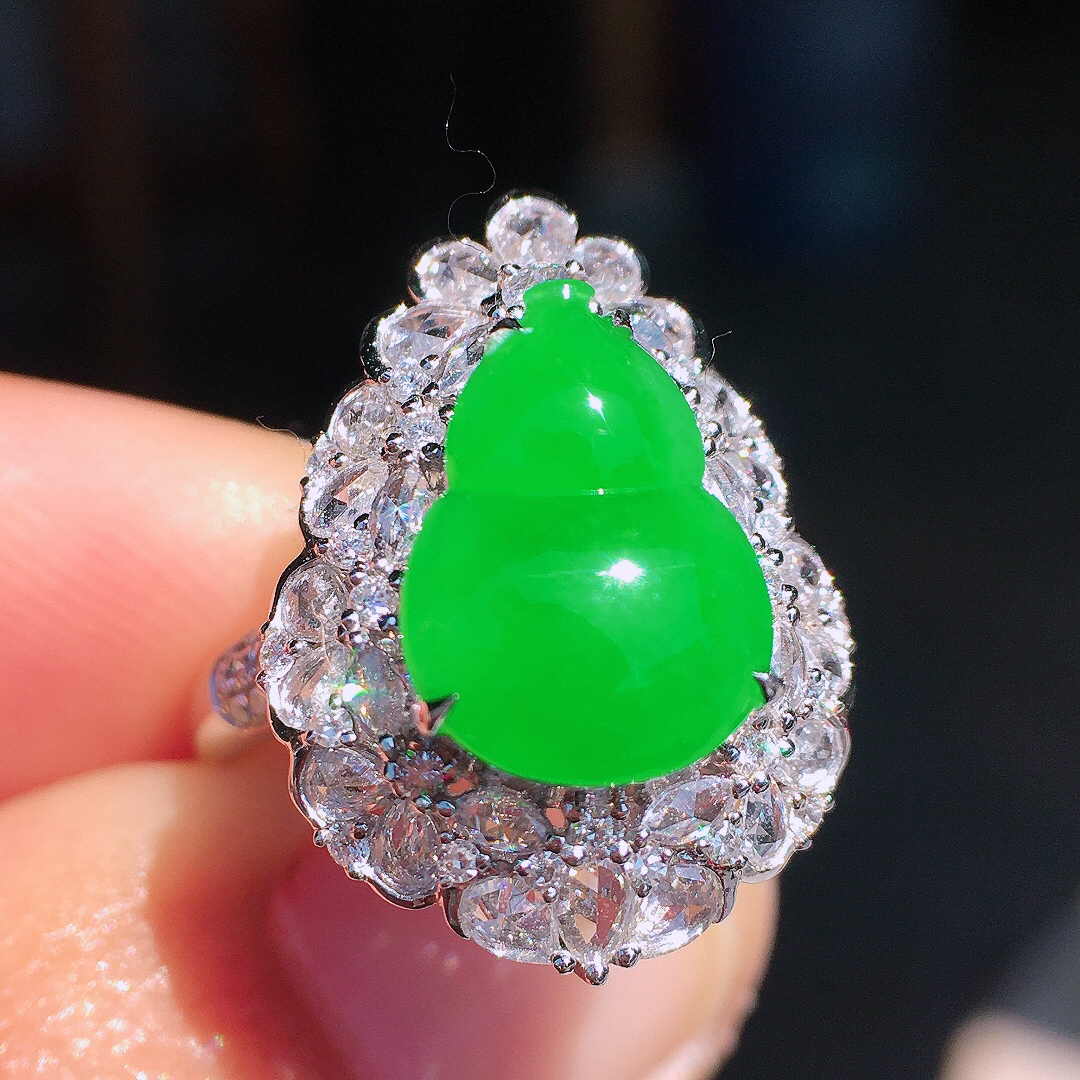 正阳绿葫芦戒指，色泽均匀艳丽，玉质细腻，荧光感超
强，饱满圆润，尽显优雅气质，18k
金豪华镶嵌