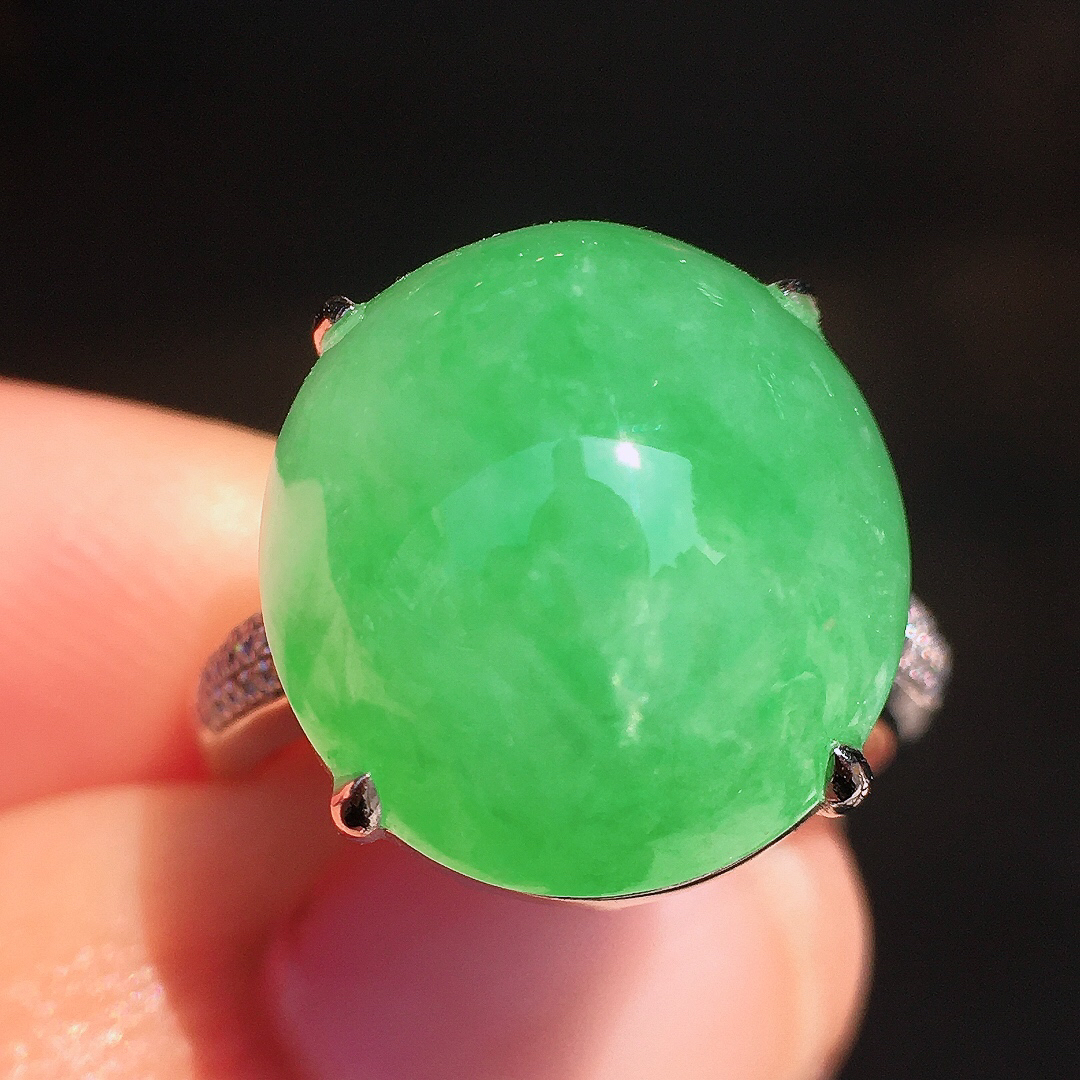 阳绿蛋面戒指，色泽均匀艳丽，玉质细腻，荧光感超
强，饱满圆润，尽显优雅气质，18k
金豪华镶嵌