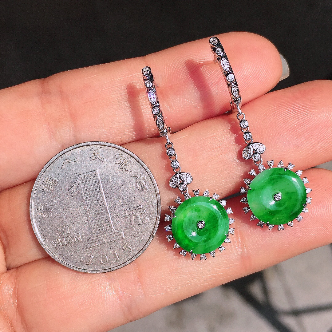阳绿平安扣耳坠，色泽均匀艳丽，玉质细腻，荧光感超
强，饱满圆润，尽显优雅气质，18k
金豪华镶嵌