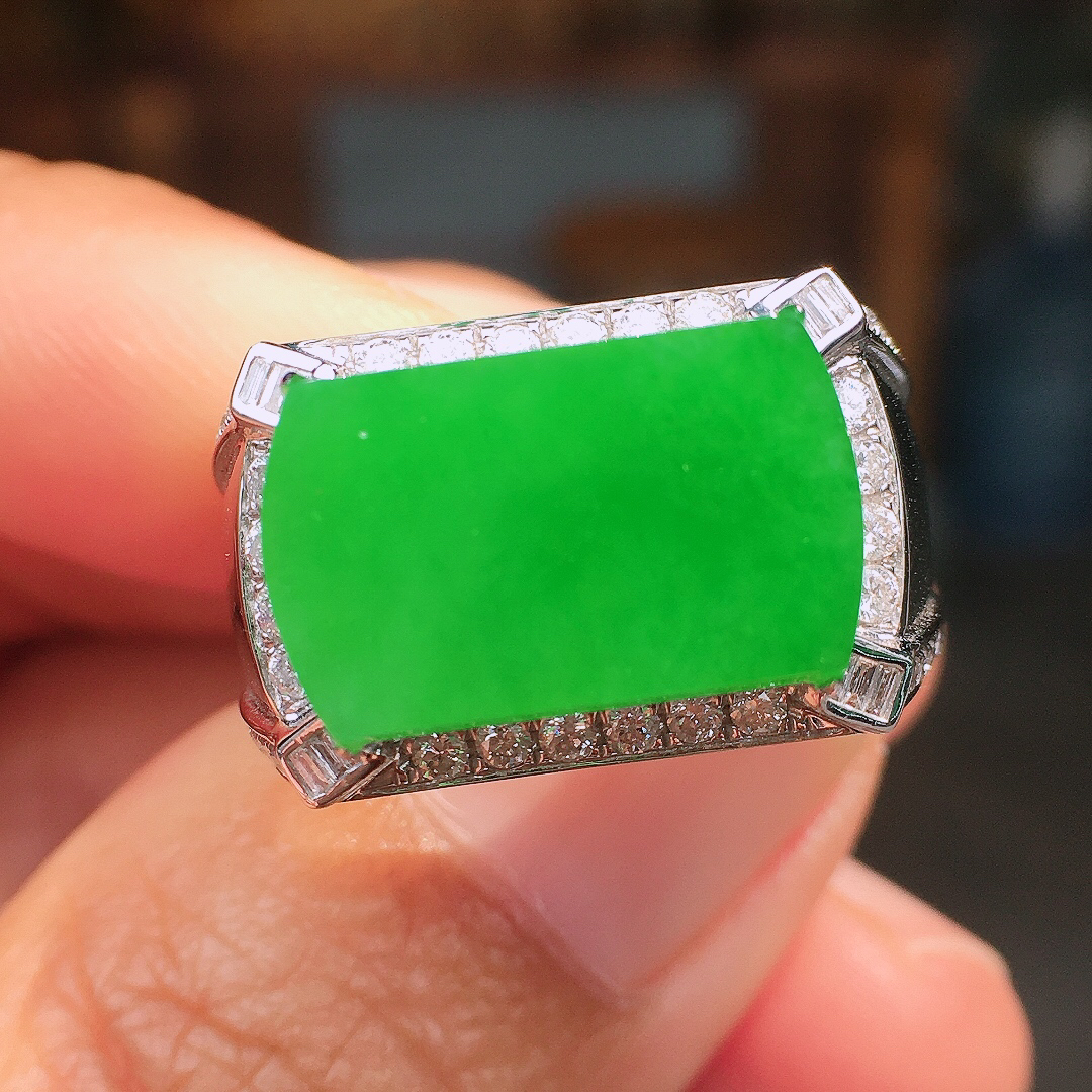 阳绿马鞍戒指，色泽均匀艳丽，玉质细腻，荧光感超
强，饱满圆润，尽显优雅气质，18k
金豪华镶嵌