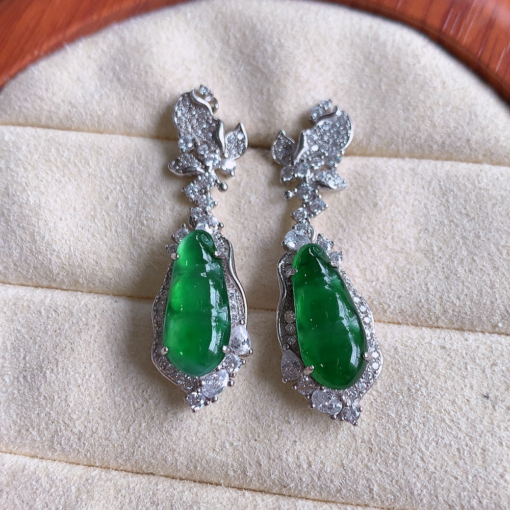冰满绿翡翠925银镶嵌福豆耳钉，自然光实拍，翠色灵动，颜色漂亮，种老水足，品相佳，佩戴佳品！W502.28  取一整体尺寸：36.5-10.2-6.3mm  裸石尺寸：14.8-6.6mm
