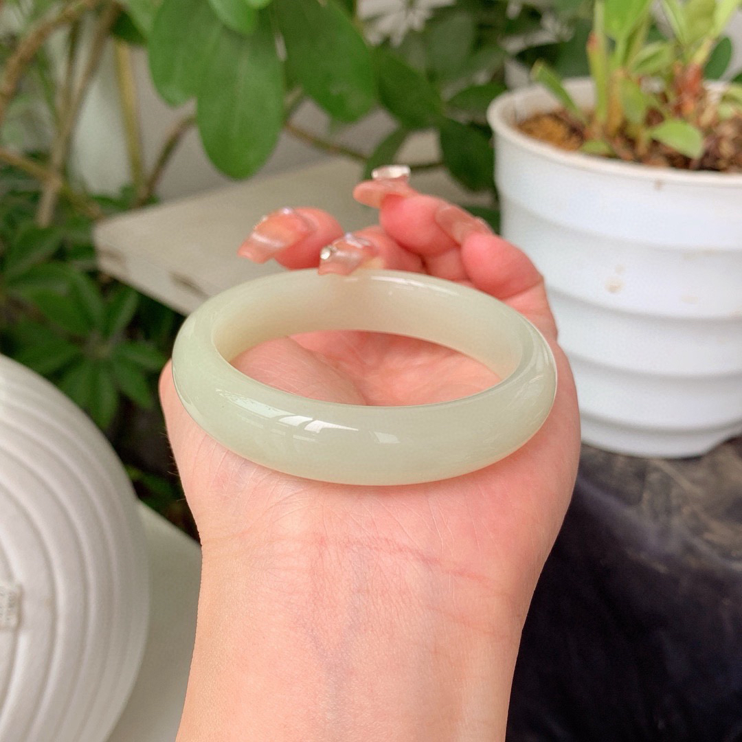 私人专拍超低价放漏，特批赠送手串一个
和田玉52.8圈口青白色手镯！重46.9克玉质细腻油润 底色纯净 无裂无杂 脂粉好，品质好！图为自然光拍摄