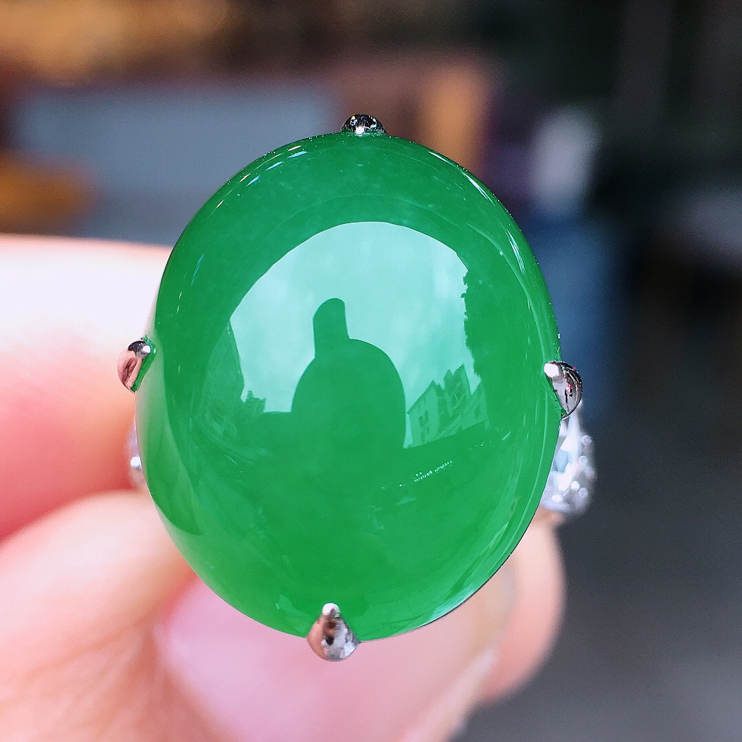 阳绿蛋面戒指，色泽均匀艳丽，玉质细腻，荧光感超
强，饱满圆润，尽显优雅气质，18k
金豪华镶嵌