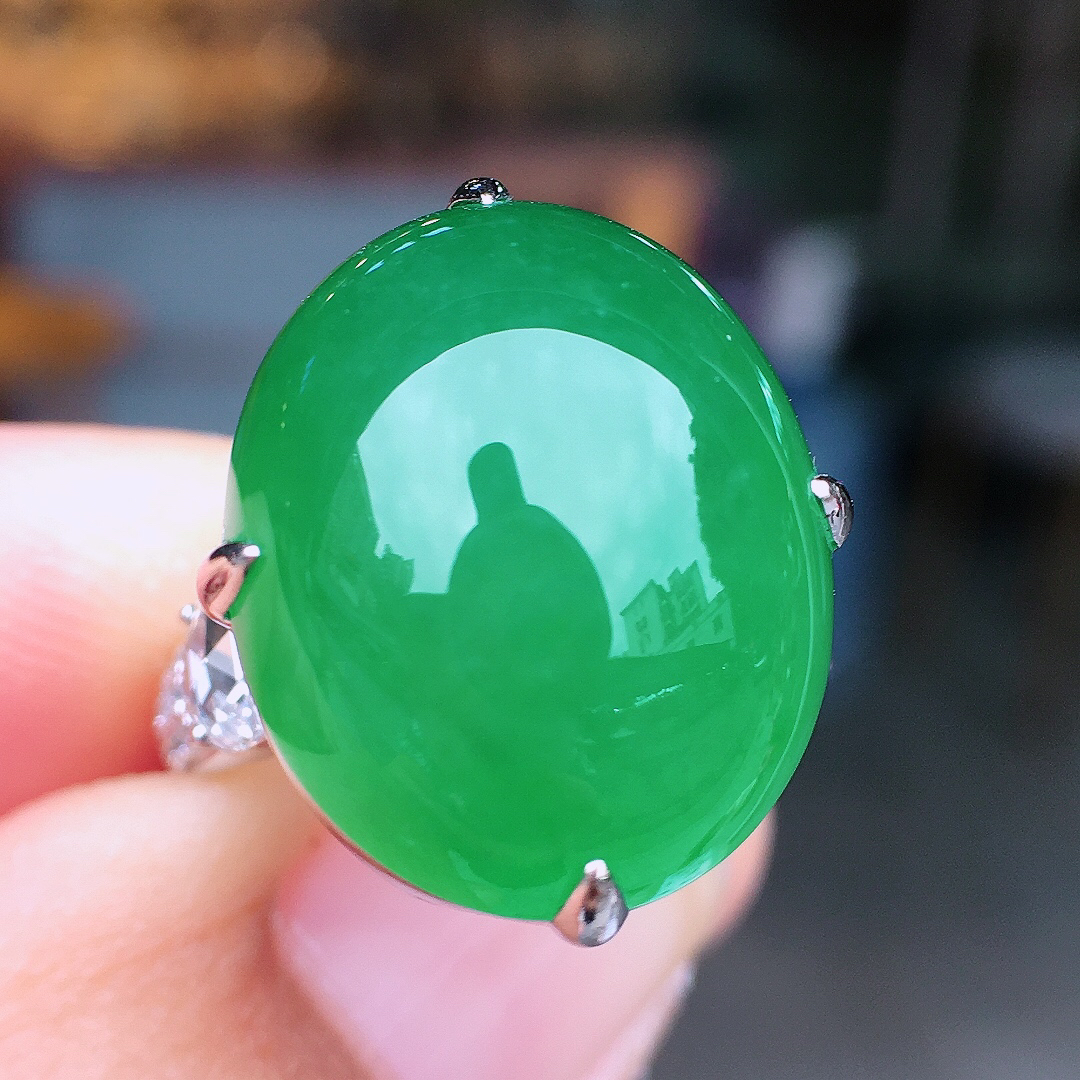 阳绿蛋面戒指，色泽均匀艳丽，玉质细腻，荧光感超
强，饱满圆润，尽显优雅气质，18k
金豪华镶嵌