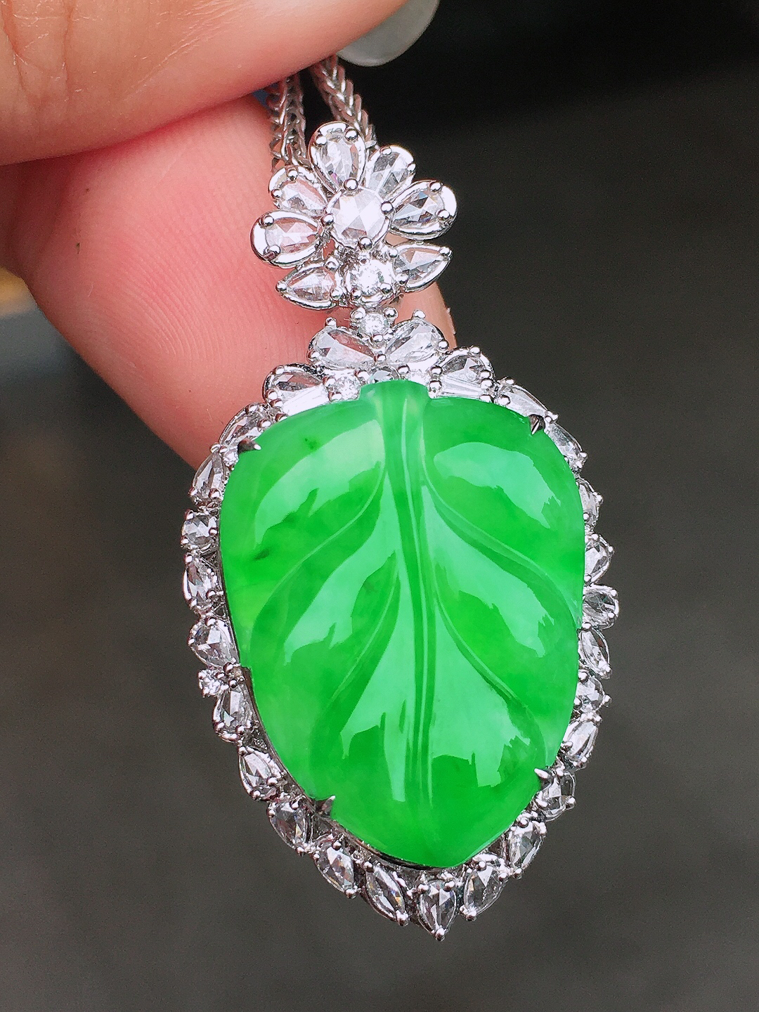 阳绿玉叶吊坠，色泽均匀艳丽，玉质细腻，荧光感超
强，饱满圆润，尽显优雅气质，18k
金豪华镶嵌