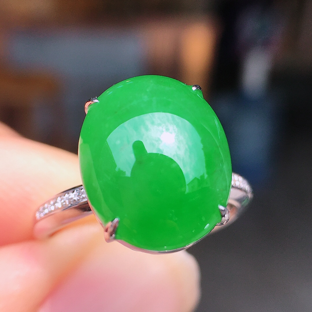阳绿蛋面戒指，色泽均匀艳丽，玉质细腻，荧光感超
强，饱满圆润，尽显优雅气质，18k
金豪华镶嵌