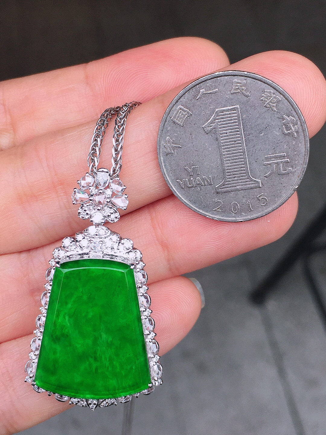 阳绿无事牌吊坠，色泽均匀艳丽，玉质细腻，荧光感超
强，饱满圆润，尽显优雅气质，18k
金豪华镶嵌