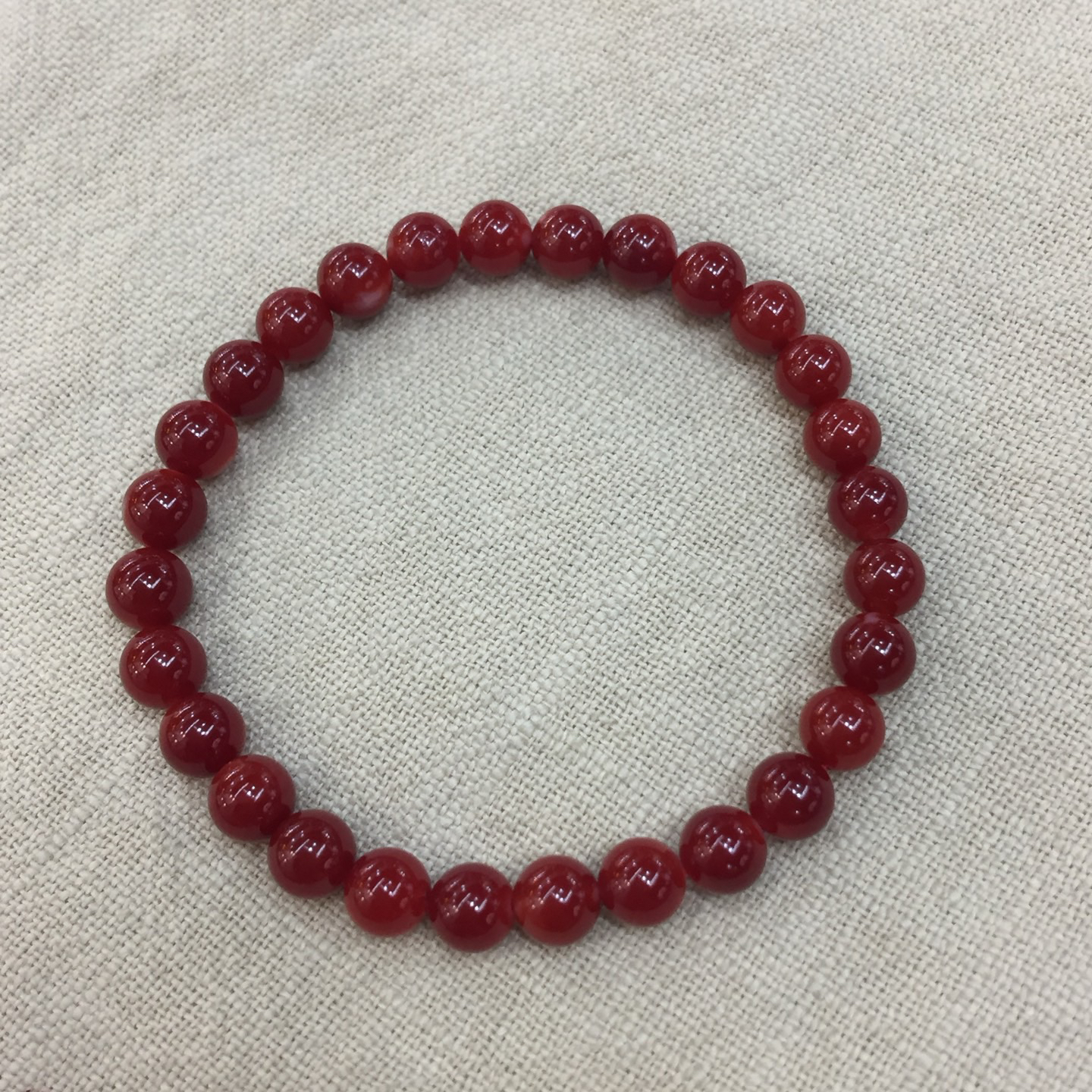 【日本阿卡赤血牛血红珊瑚6.8mm圆珠弹力单圈手串】天然无添加无优化，日本产地，阿卡材料、难得高瓷度，整条少白芯的阿卡圆珠。整条赤血牛血红颜色，珠子直径6.8-6.11mm，每颗珠子均为天然的珊瑚，珊瑚自古就为佛教珍宝，深海千年有机宝石！收藏价值高、可传承！总重10克！追求品质者的福音！实物漂亮！