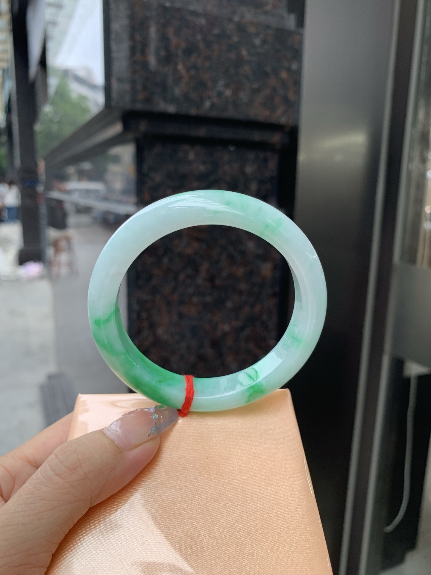 白底青正圈 57-8.4-11.6 0509-N673 打灯细纹，不影响，底妆冰润，半圈阳绿花点缀腕间风华，干净纯净的底色上，一抹翠色肆意流淌，宛如春日里的繁华盛景