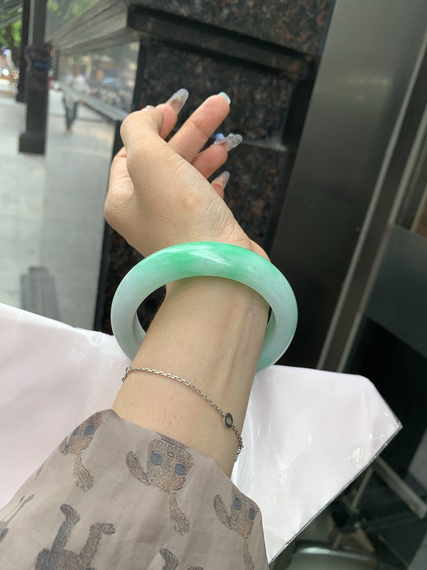白底青阳绿正圈 60-9.7-14.6 0512-N705 打灯细纹，半圈阳绿花点缀腕间风华，干净纯净的底色上，一抹翠色肆意流淌，宛如春日里的繁华盛景