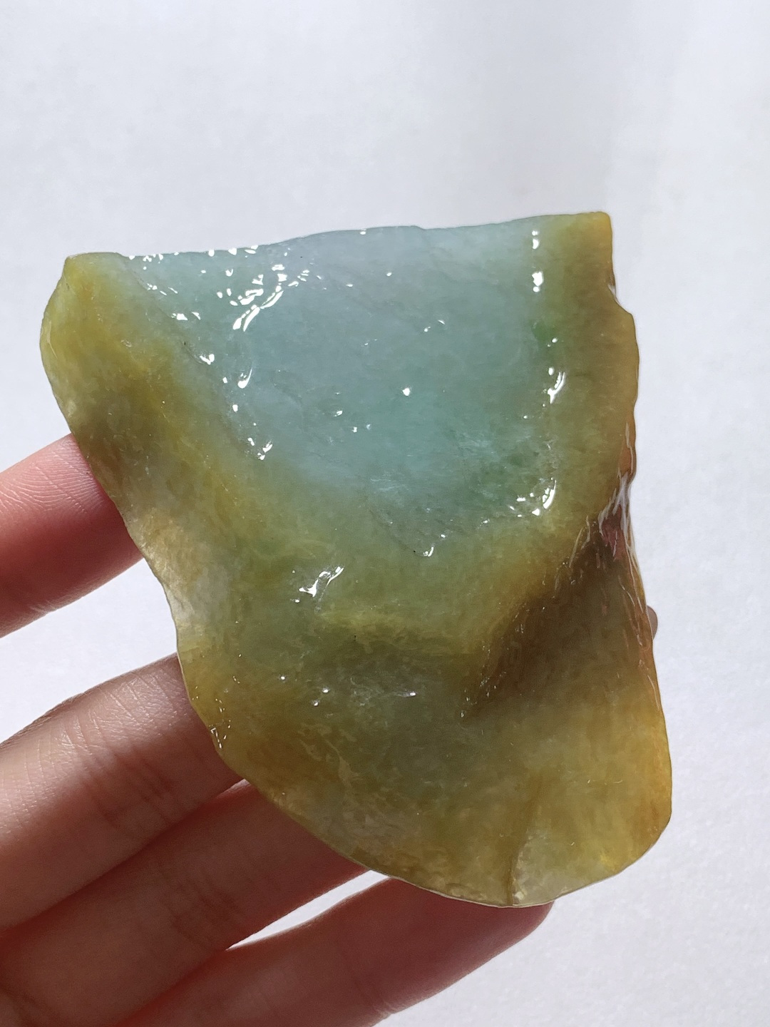 【材料】🫧 冰黄加绿/牌子料/片料/板料/特色料【题材】可做牌子、人物、山水、动物、花件……等推荐参考【尺寸】71.9-64.1-8.6【重量】81.1克· 黄皮围翠藏秋韵，碧水凝莹蕴玉灵。·天然黄加绿翡翠原石，外圈暖黄翡皮裹着内里清润湖绿，玉质水润通透、肌理莹亮，俏色层次浑然天成，可巧雕山水随形牌，借黄皮雕琢峻岭、翠色勾勒溪泉，山水题材寓意坐拥福禄、山水纳祥，天然原石自带山野悠然意境，雕琢后古朴雅致，佩戴收藏皆宜。