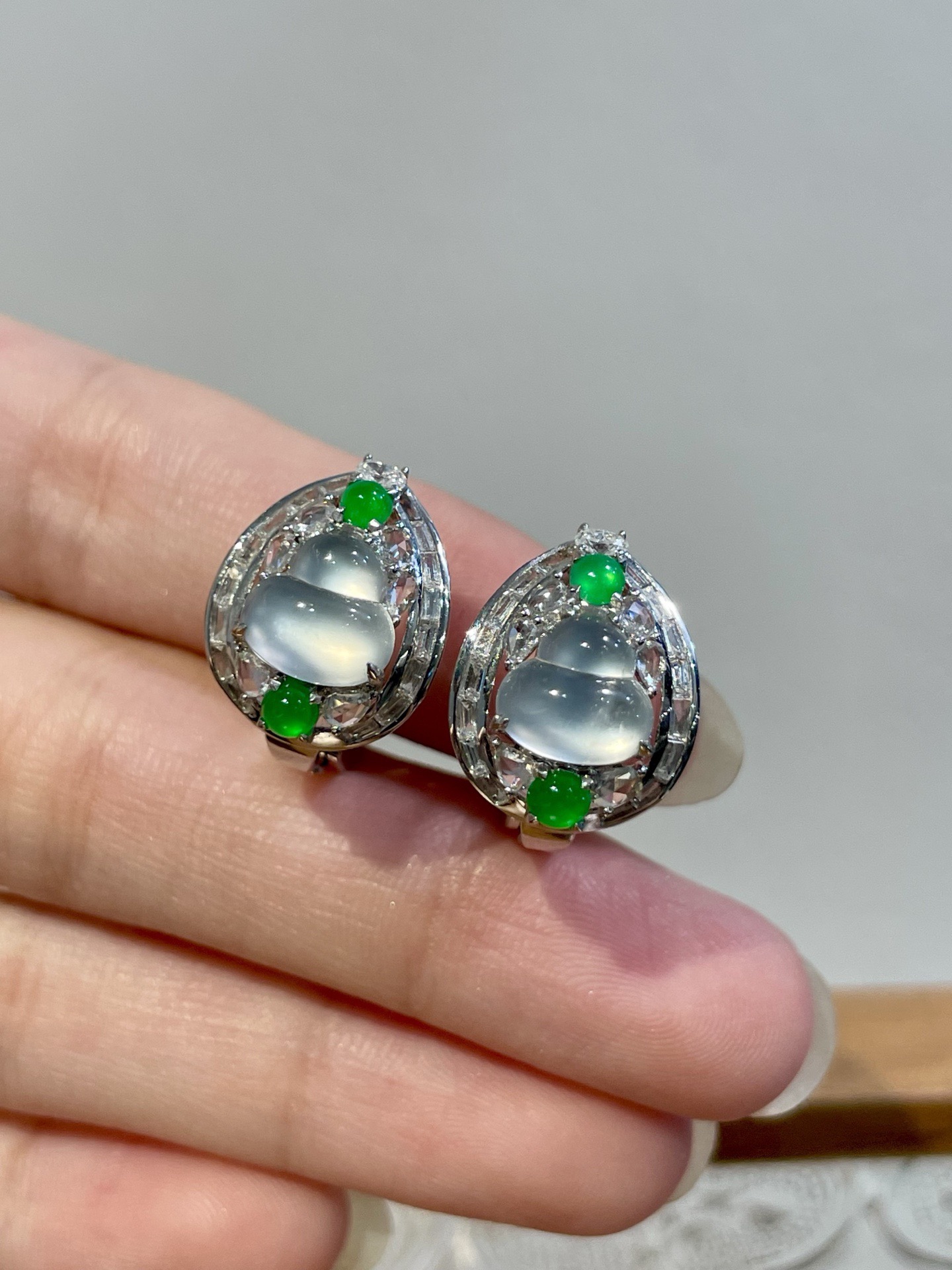 18k玻璃种葫芦耳扣 作为耳扣，佩戴感同样贴心：耳扣开合处暗藏弹簧设计，轻按即可扣合，走动或转头时，葫芦会随动作微微晃动，玻璃种的冷光便在耳畔流转，似有“福禄随身”的灵动感，却无多余声响，安静又吸睛 尺寸：16.4*12.5*17.1 裸石：7.5*7.7*3.2
