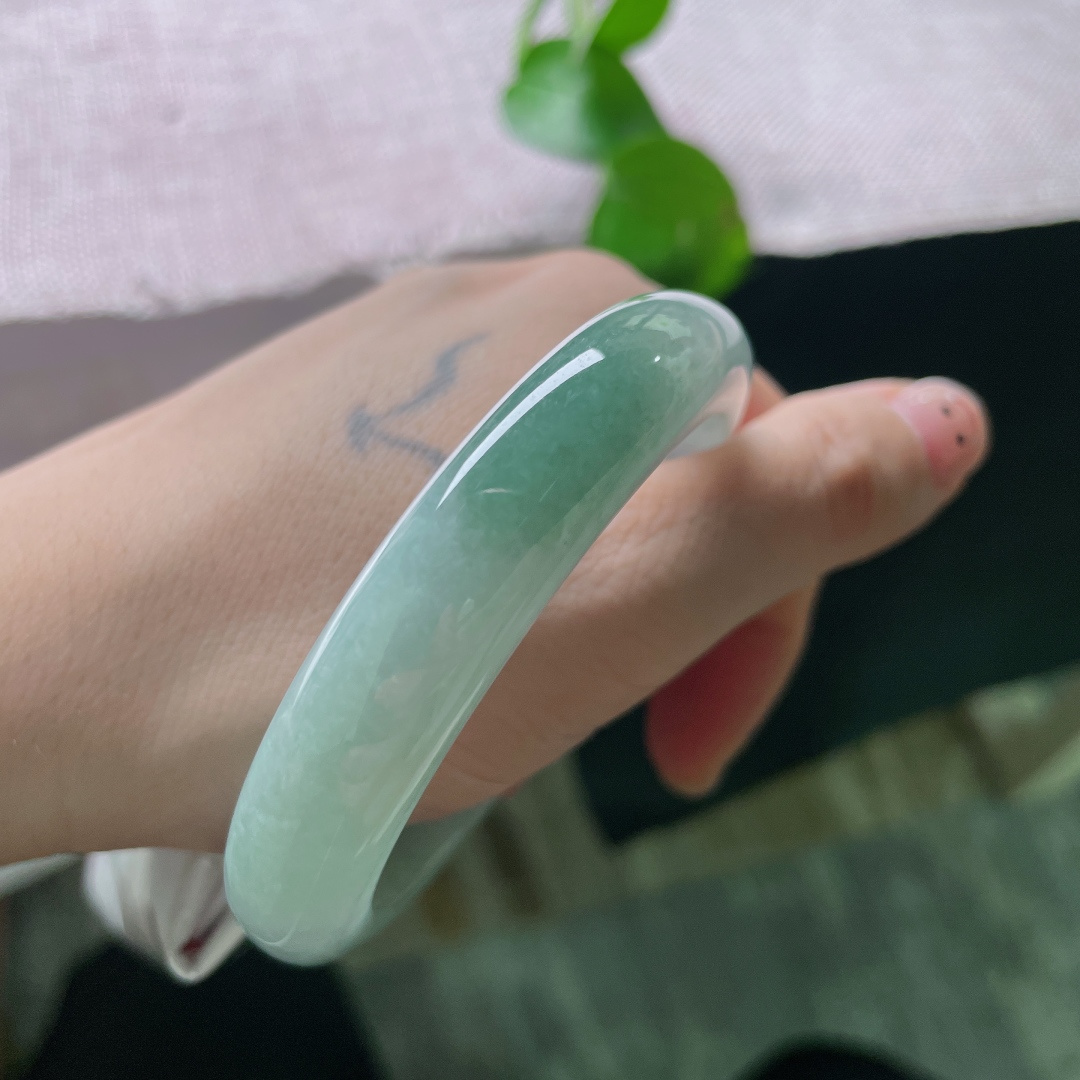 蓝底飘色正圈，底色清透柔和，镯身晕开一抹油绿色，温润动人。腕间轻绕，藏着清简治愈的东方温柔。无裂，ss52412a