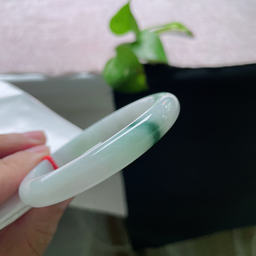 53.9/9.2/7.9，飘花正圈，无裂，底子通透干净，一侧聚敛浓郁深绿飘花，色彩对比鲜明，纤细镯身轻盈秀气，上手精致小巧。ss57123a