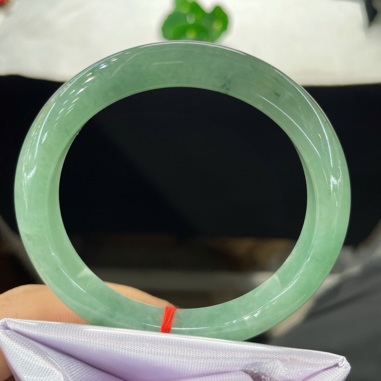 圈口58.6/10.2/8.2，果绿正圈，58/59可戴，仿若碧涧含烟，质地温润澄澈。清润湖绿。无裂。