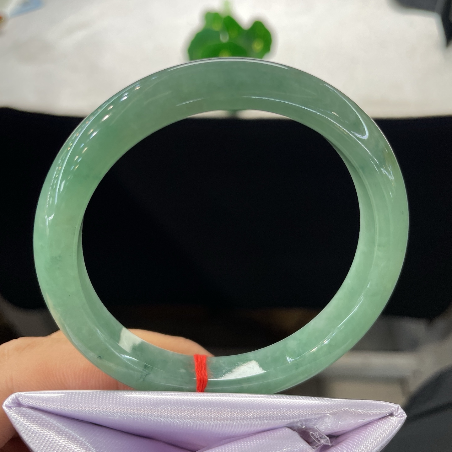 圈口58.6/10.2/8.2，果绿正圈，58/59可戴，仿若碧涧含烟，质地温润澄澈。清润湖绿。无裂。