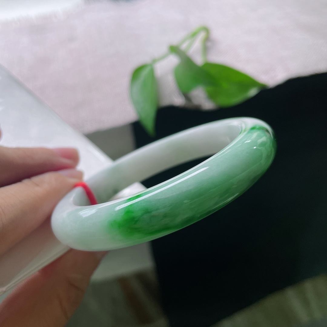 白底青正圈，一点皮纹，素净洁白玉底，艳润的辣绿恣意晕染，翠色浓烈鲜活，上手自带古典明媚的氛围感。ss57987a