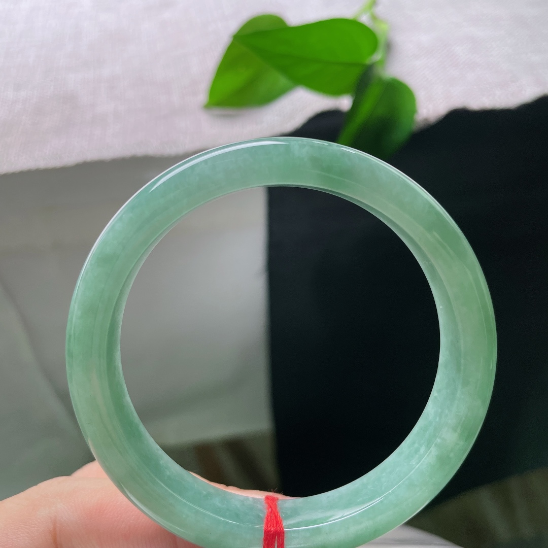 绿底正圈，一点皮纹，色调柔和均匀，玉面光泽温润，如同山间一汪浅潭，清润不张扬，日常佩戴温柔显气质。s