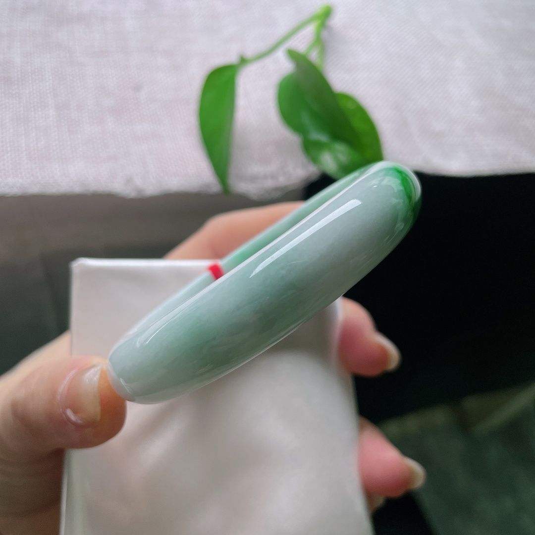 飘绿正圈，有纹，辣绿耀眼，冰润莹白玉底之上，一抹浓艳正阳绿沿镯身迤逦铺展，翠色浓郁鲜活，贵气天成。ss57988a