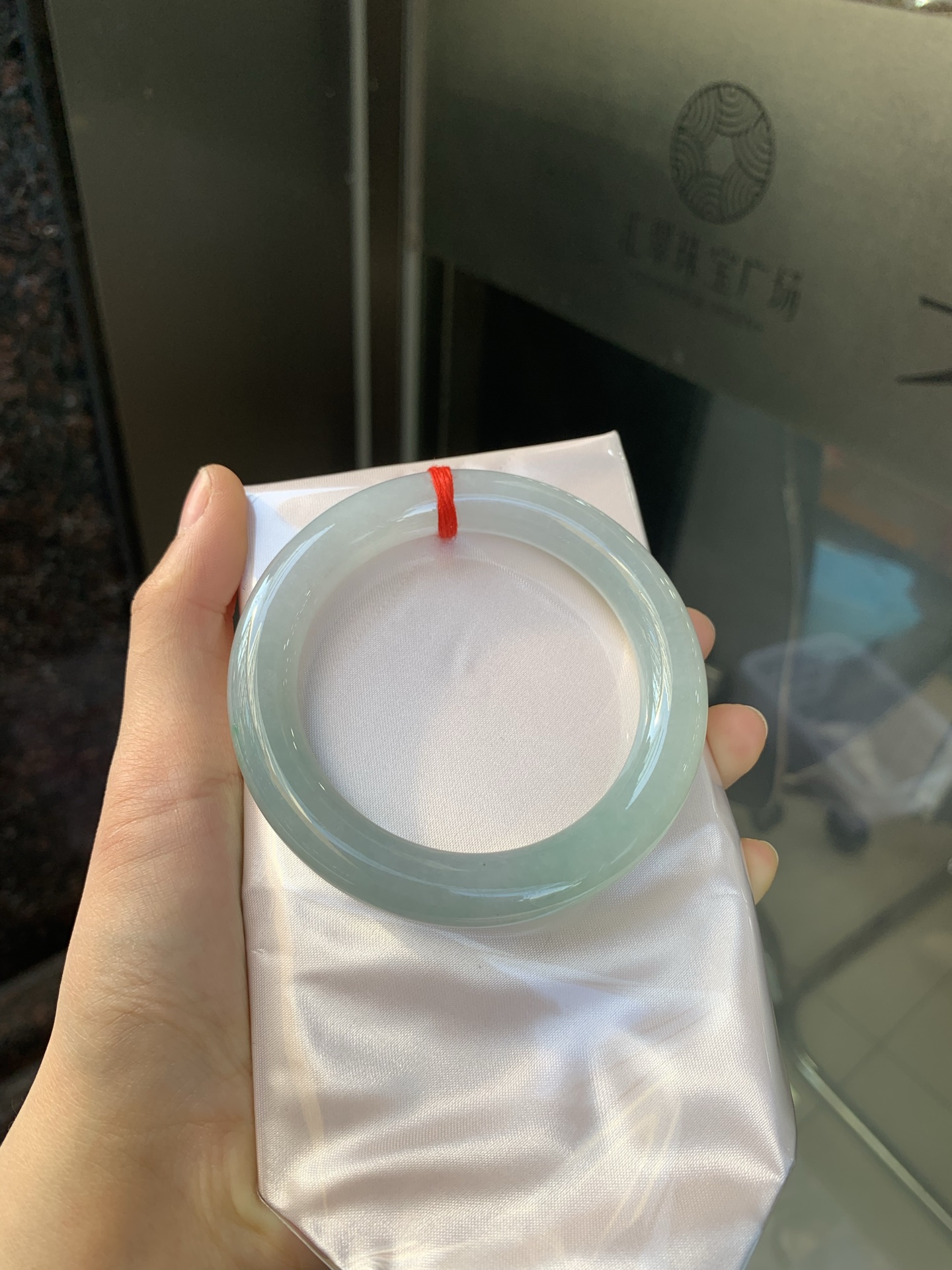 冰油圆条，打灯两处细纹，玉质冰润，油青底飘一小朵绿花，点睛之笔，彰显韵味