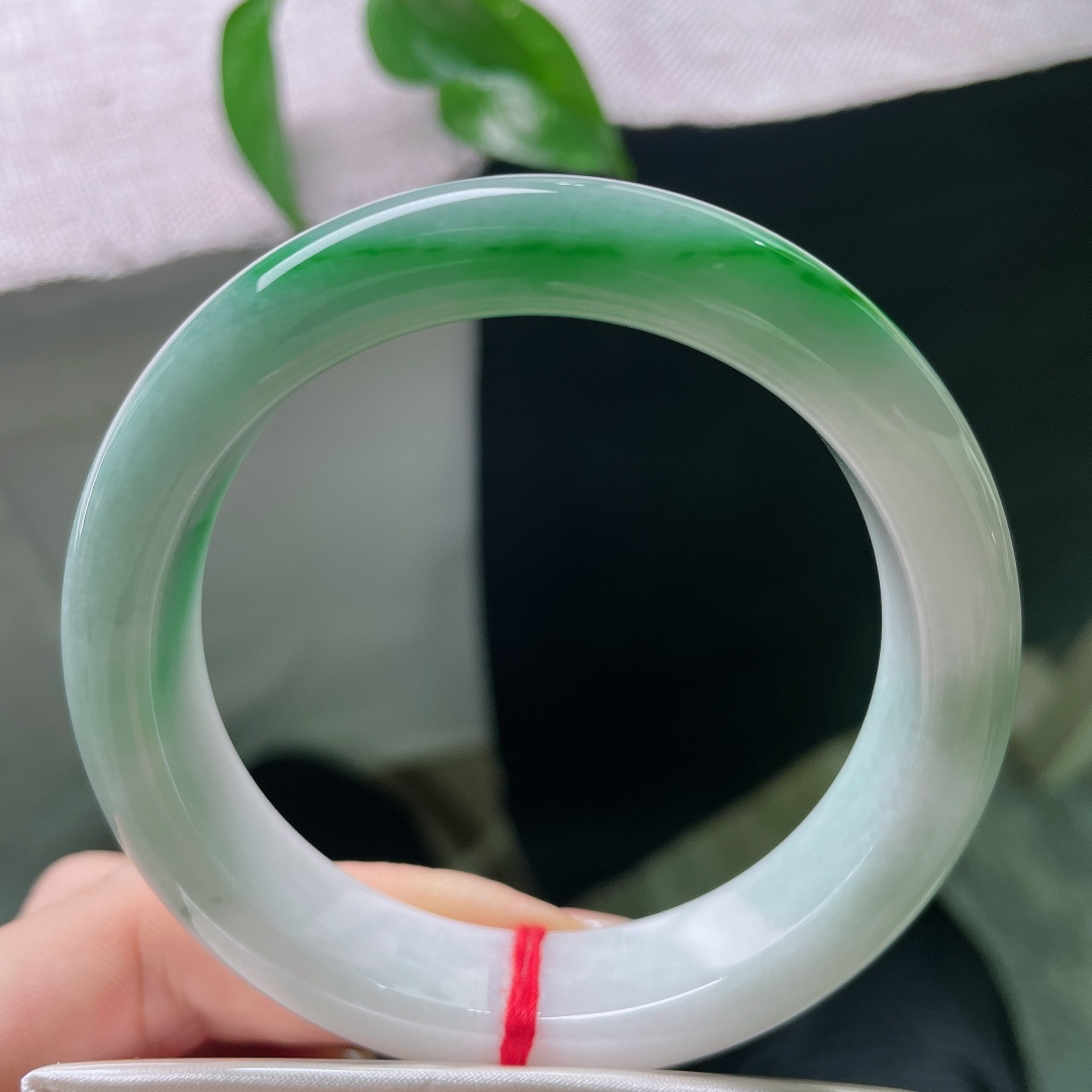 飘绿正圈，有纹，辣绿耀眼，冰润莹白玉底之上，一抹浓艳正阳绿沿镯身迤逦铺展，翠色浓郁鲜活，贵气天成。s