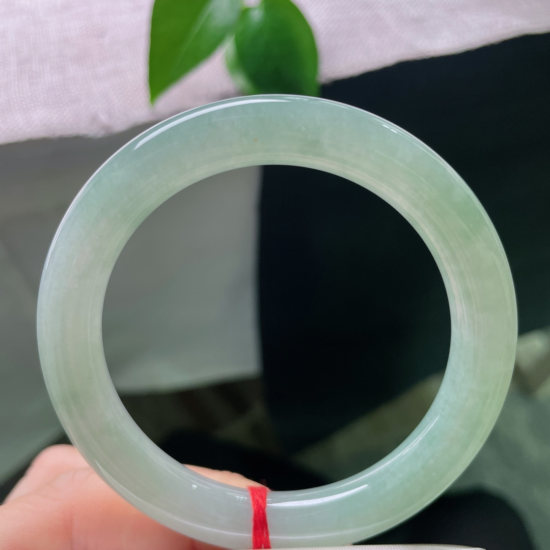 绿底圆条，一点皮纹，满圈漾开清润碧色，宛若一汪沉静湖水环于腕间，温柔静谧，自带悠然诗意。ss58006a