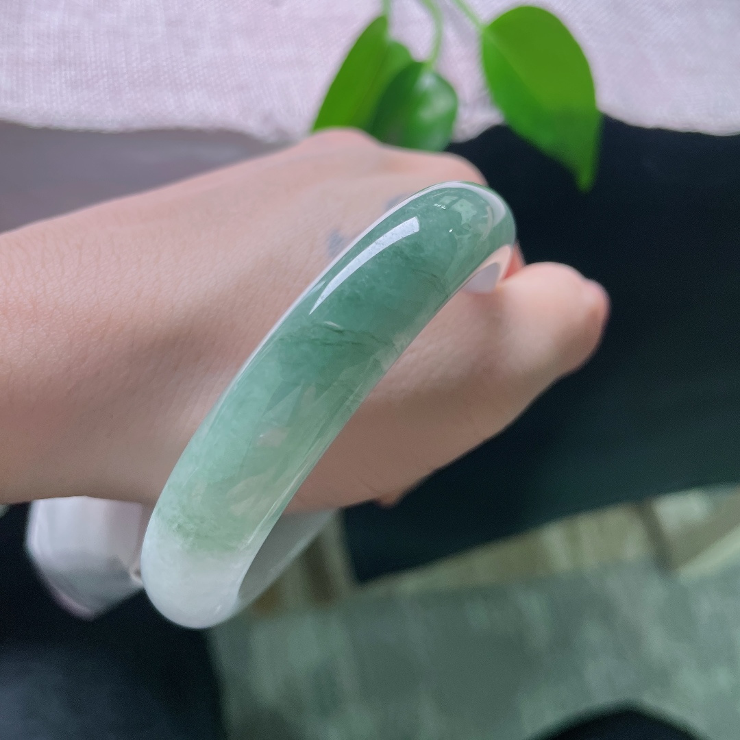 57.8/12.7/8，油青正圈，皮纹，白底与绿韵自然相融，如远山含碧水，一镯藏尽山水诗意。ss59006a