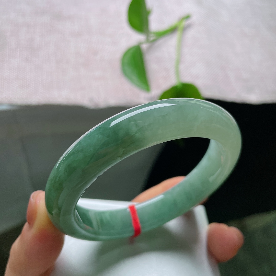 57.6/12.6/8.7，油青正圈，一点皮纹，一汪幽潭锁素环，整只镯子裹着温润的湖调青绿，不艳不烈，腕间自带一份安然清宁。ss56986a
