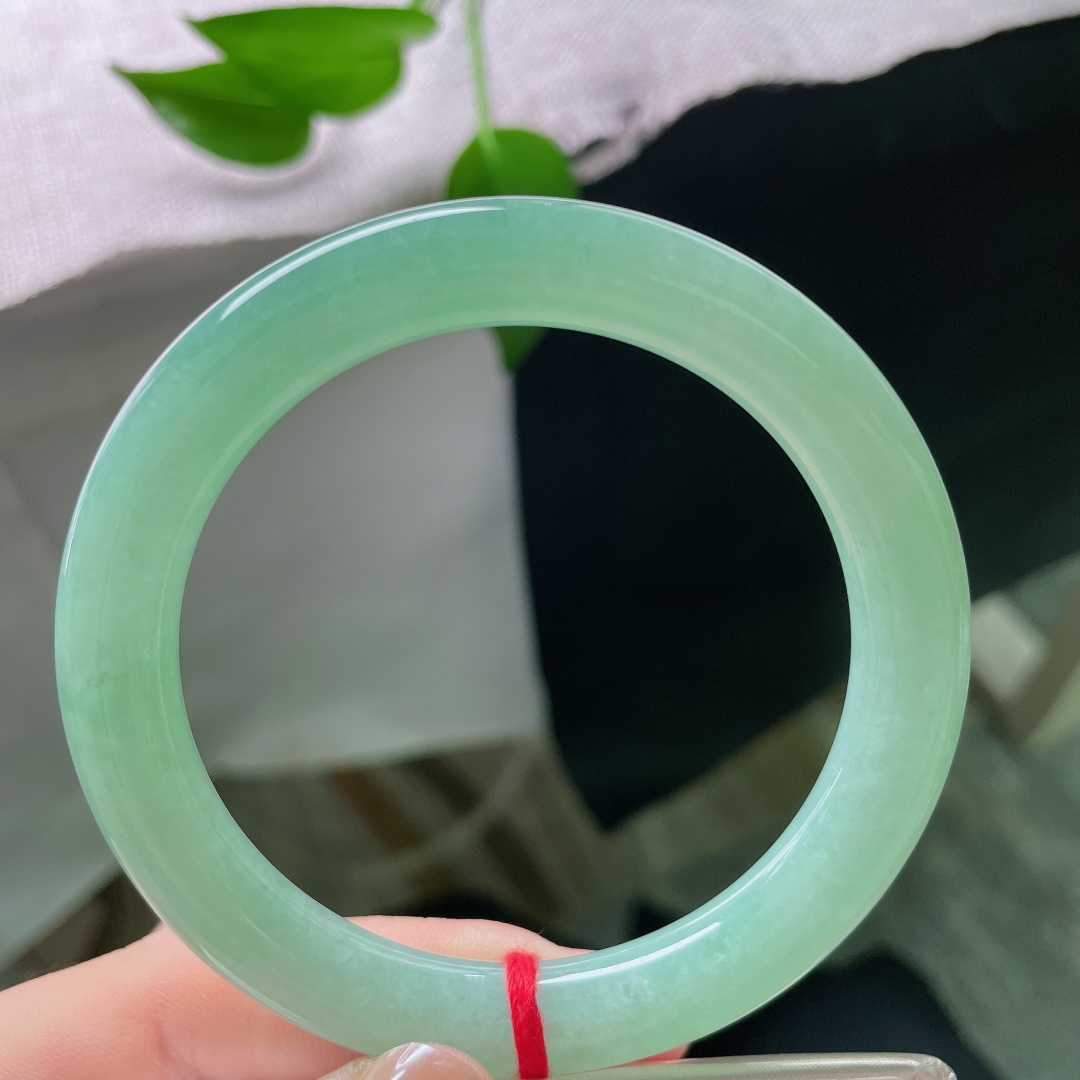 56.5/9.4，绿底圆条，无裂，玉质冰润细腻通透，柔和果绿匀净弥散，圆条线条流畅，复古形制尽显雅致