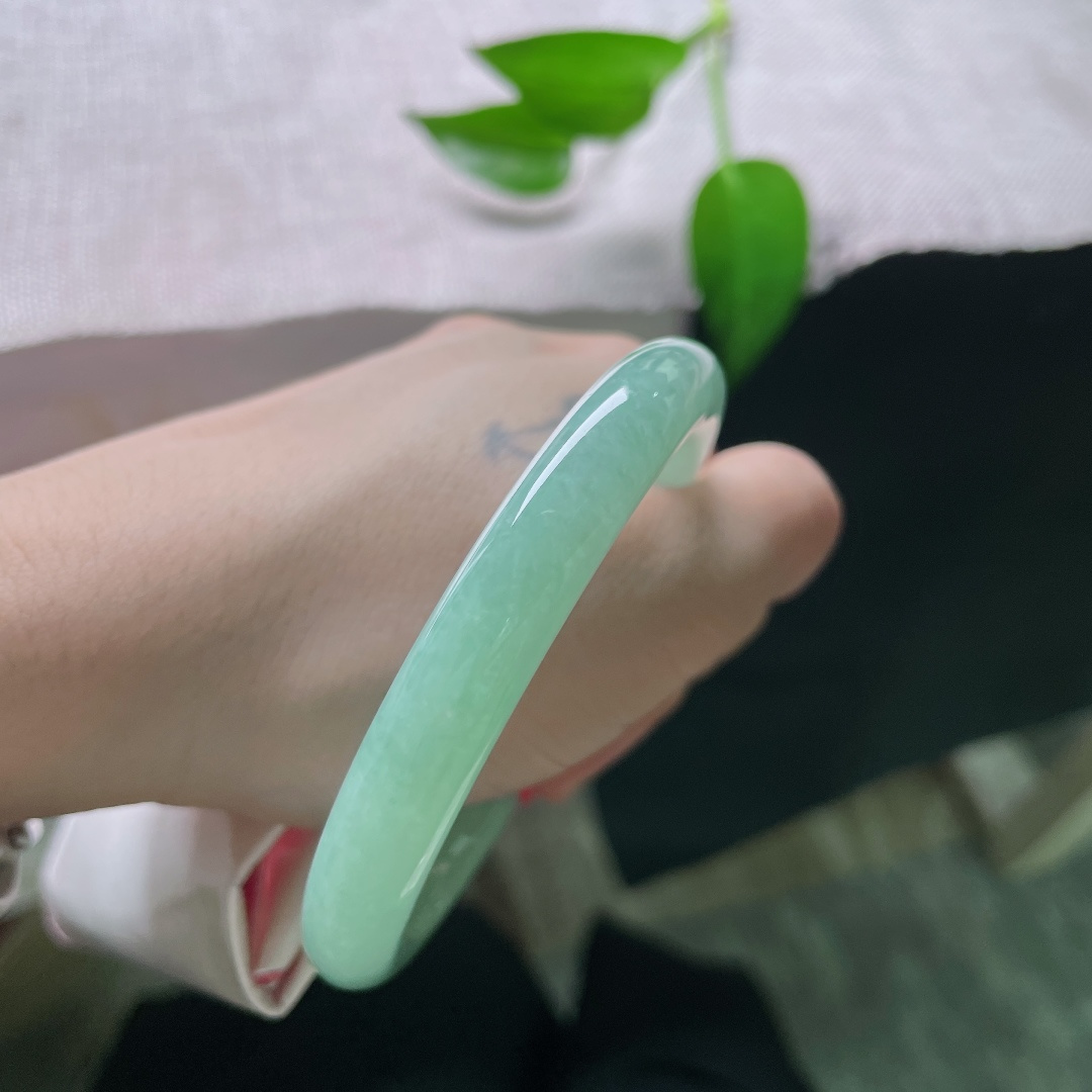 56.5/9.5，果绿圆条，无裂，水润细腻，清新的果绿浅浅晕染镯身，不深沉不艳俗，自带清甜干净的气质。ss59641a