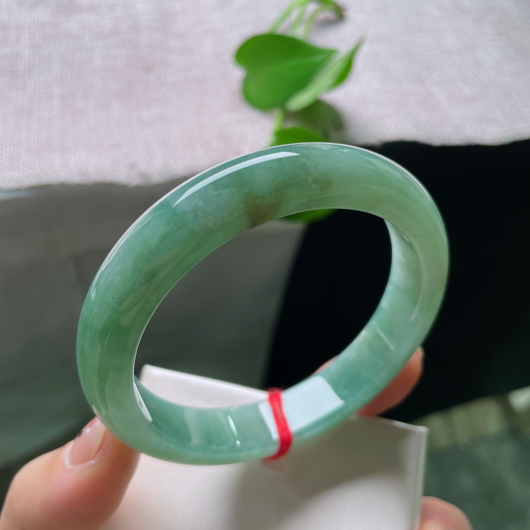 57/11.9/8.4，湖水绿飘黄翡正圈，一汪匀净湖青凝于宽厚玉镯，细腻柔光流转，素面简约尽显温润大气。ss54408a